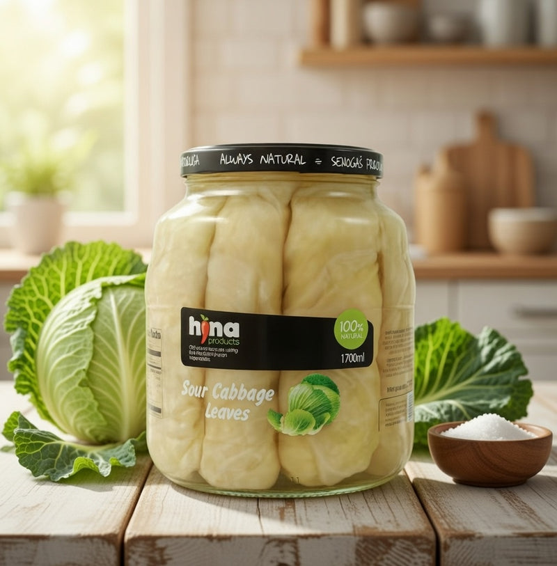 Jar of Hina Sour Cabbage Leaves on a wooden surface with a kitchen background